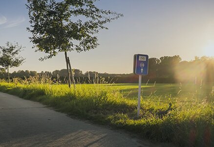 blue signpost in Kortessem by sunset